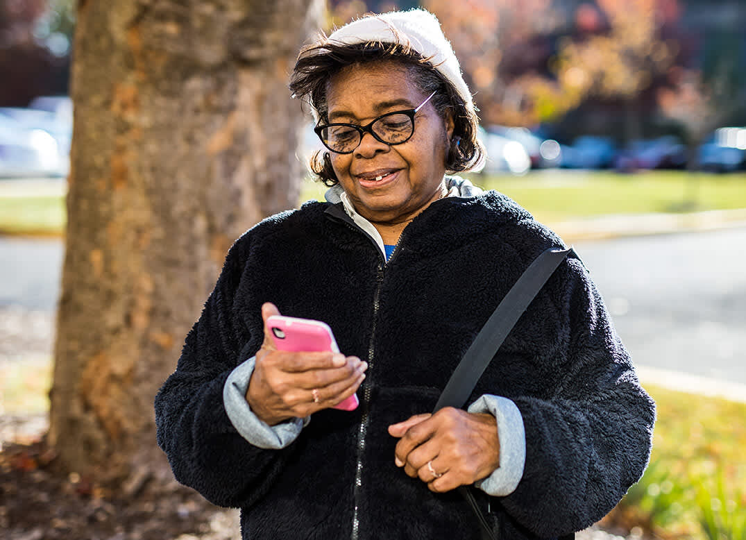 Florestine Jones ordering a Lyft on her phone to get to the grocery store.