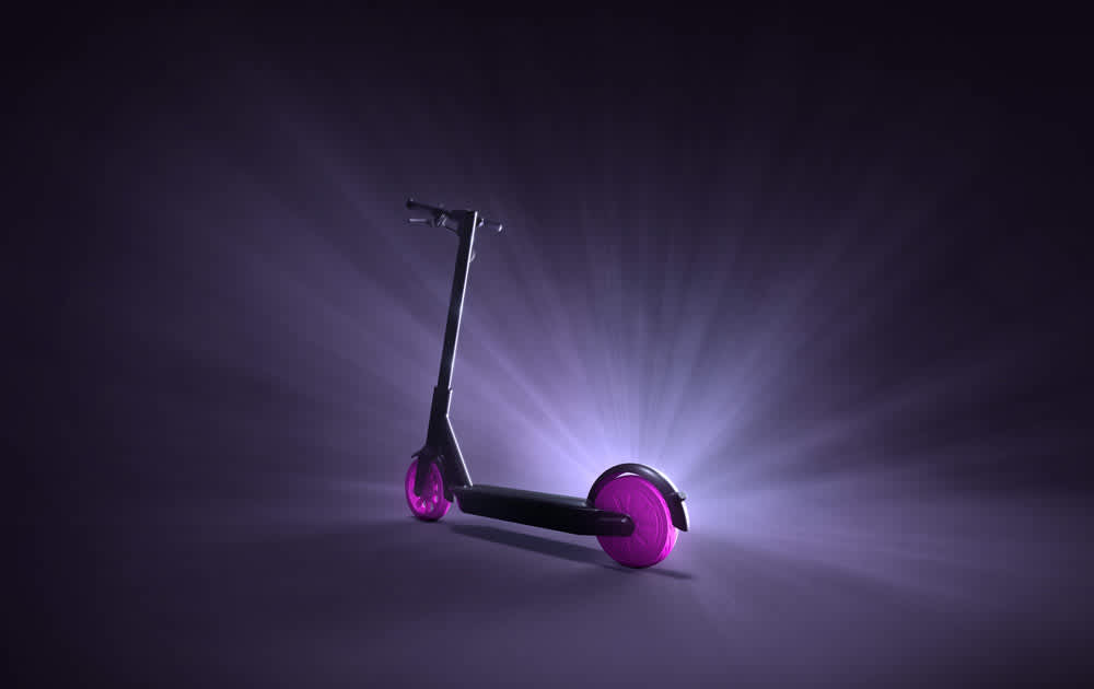 A Lyft Scooter with pink wheels in front of a black ground.