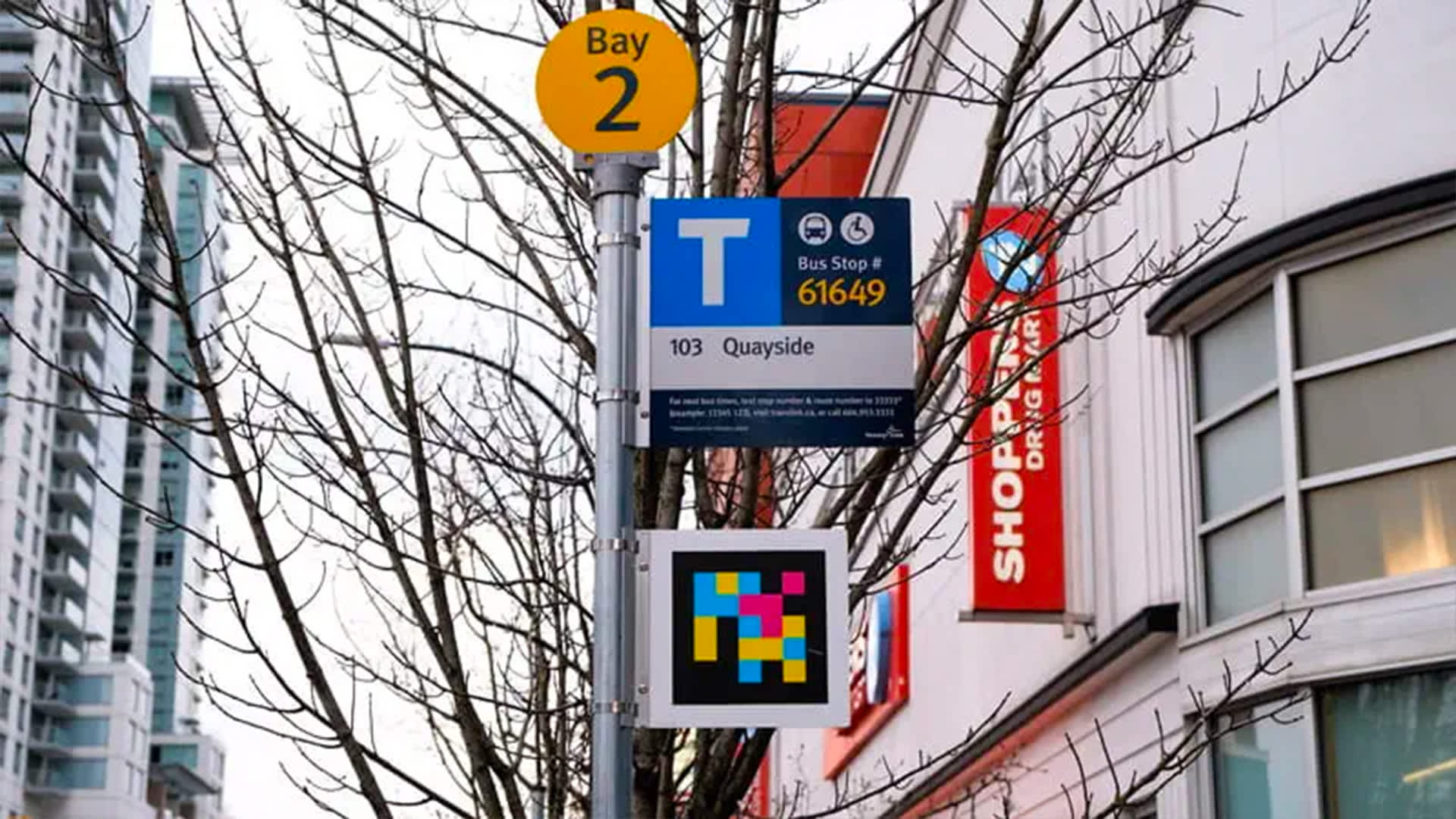 NaviLens code decal on a bus stop sign at a bus station in New Westminster, British Columbia (Image credit: Translink)