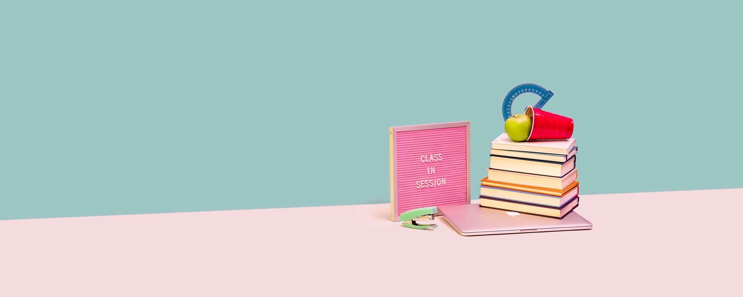 Books and a laptop on a table. 