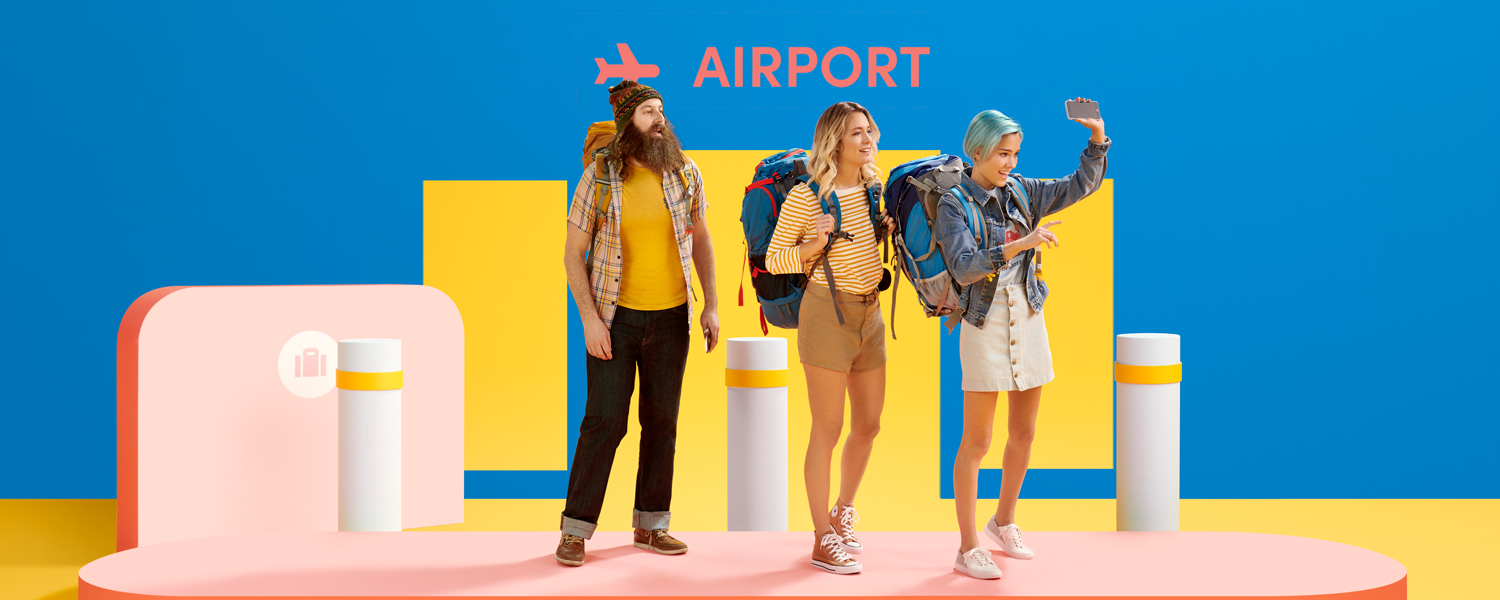 A line of three people with backpacks waiting for a Lyft at an airport.