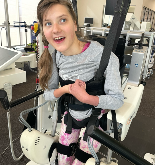 Child living with Rett syndrome at 10+ years old at physical therapy