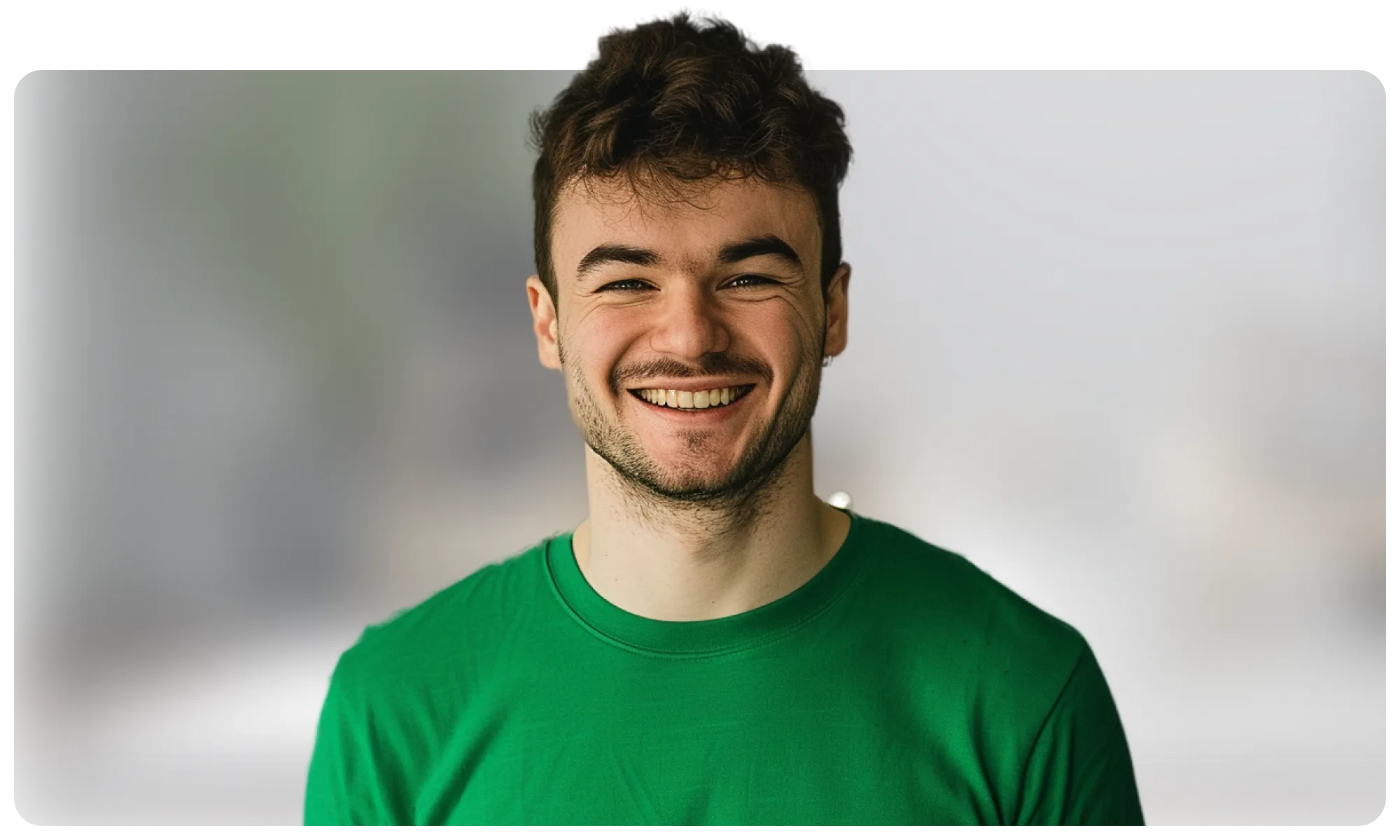 A happy man in a green tshirt