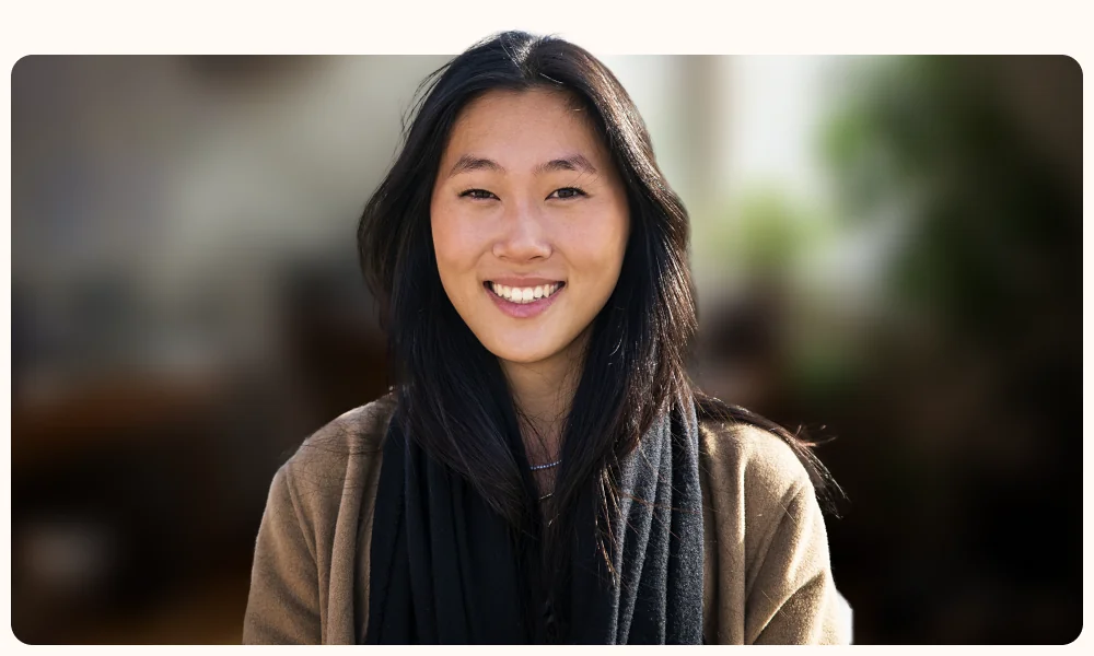 Portrait of a professional in a softly blurred office, illustrating the TestGorilla article "What a bad hire actually costs your company"
