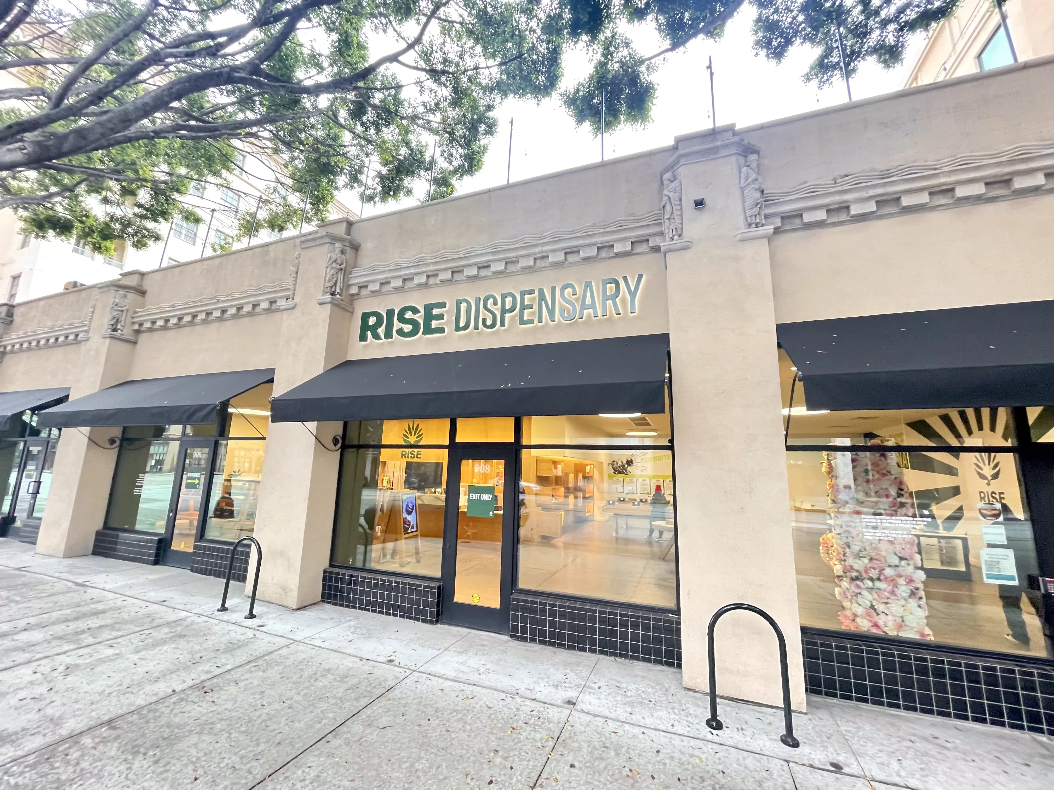 Rise Pasadena cannabis dispensary storefront with illuminated signage and green awning.