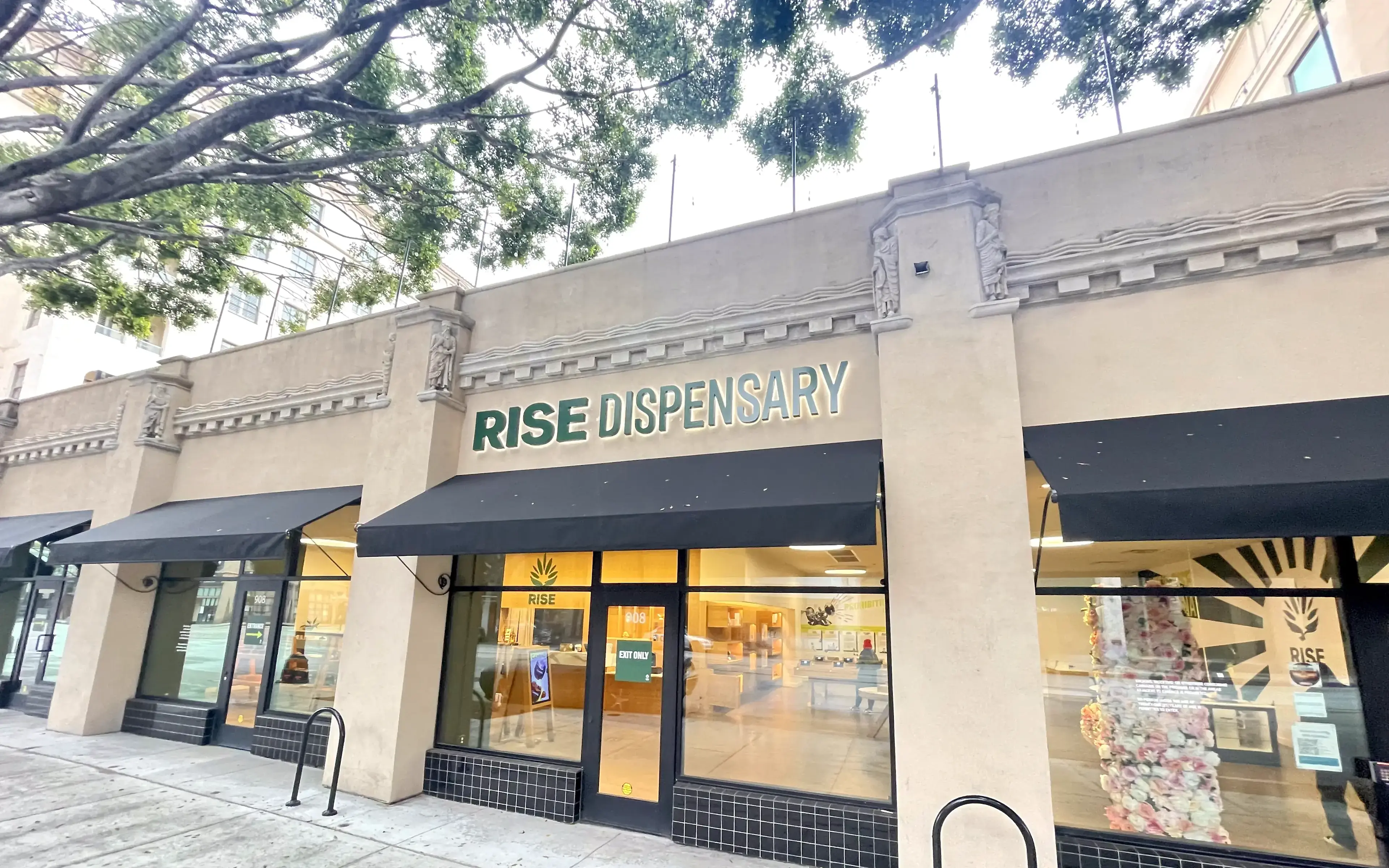 Rise Pasadena cannabis dispensary storefront with illuminated signage and green awning.