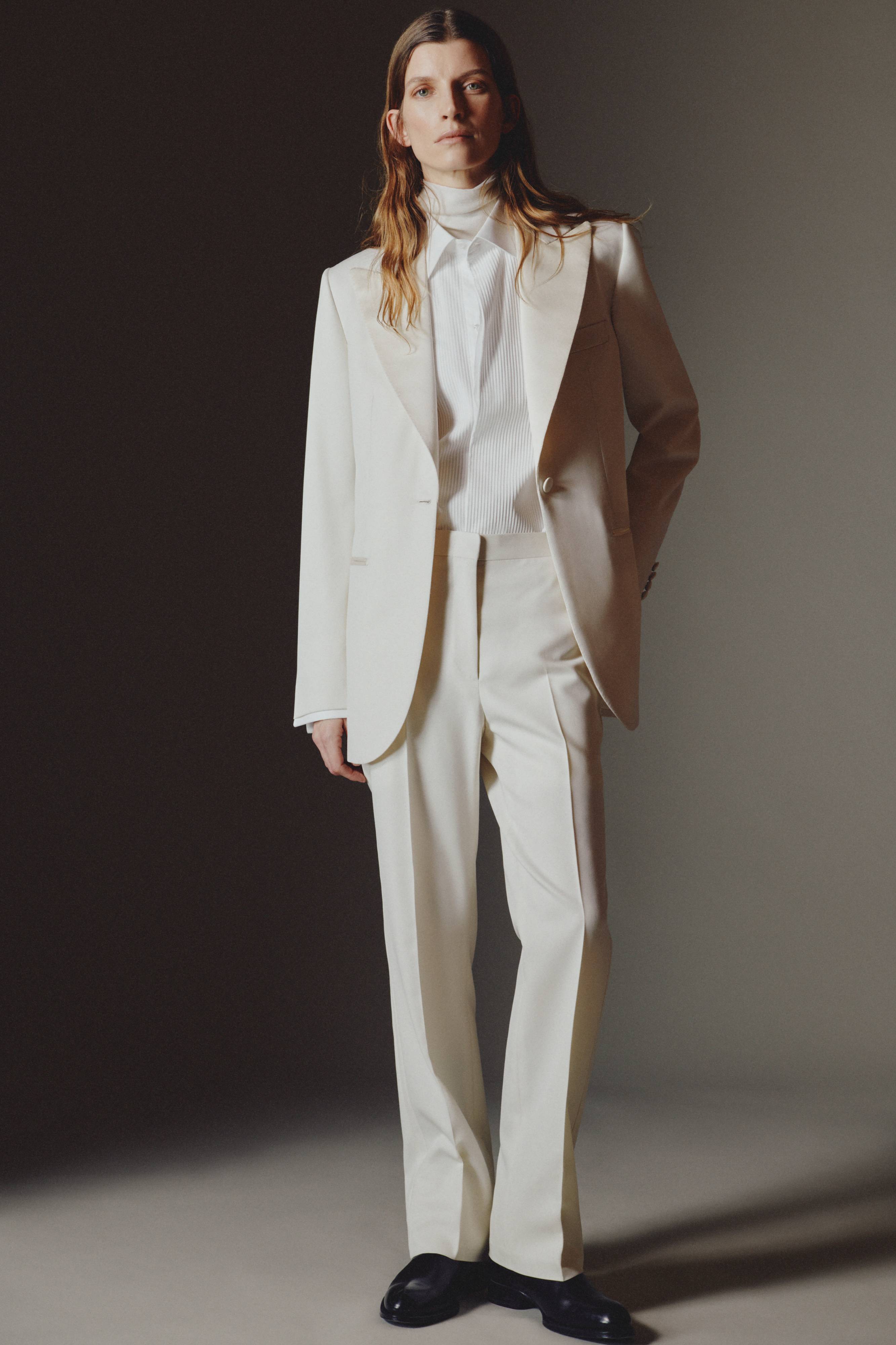 Woman model wearing white Brioni suit from capsule collection