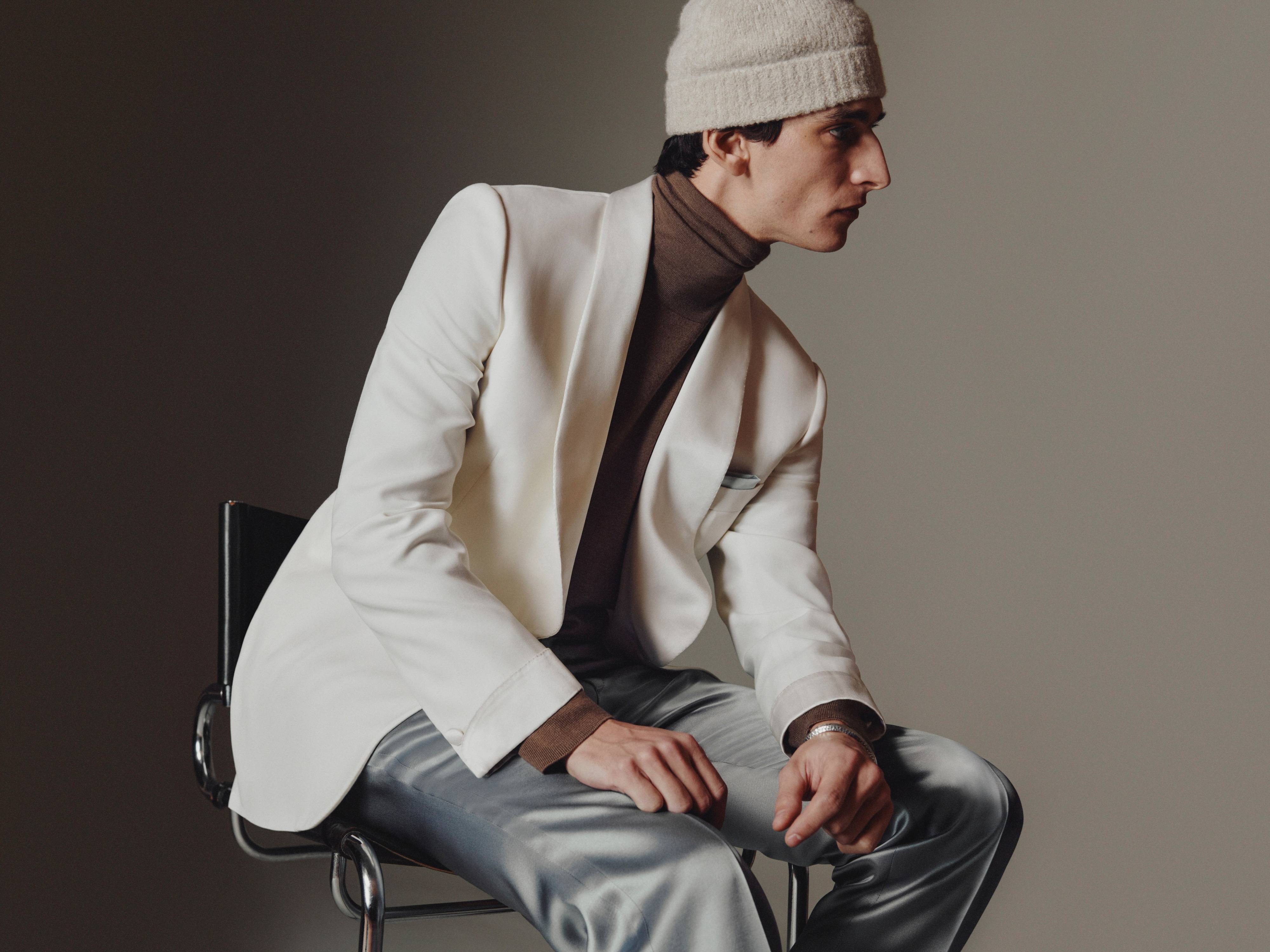 Brioni model wearing white jacket and beanie from fall winter 22