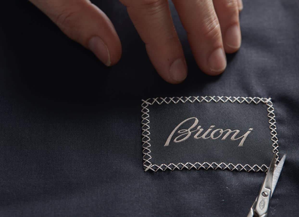 The iconic Brioni label is hand stitched on a garment