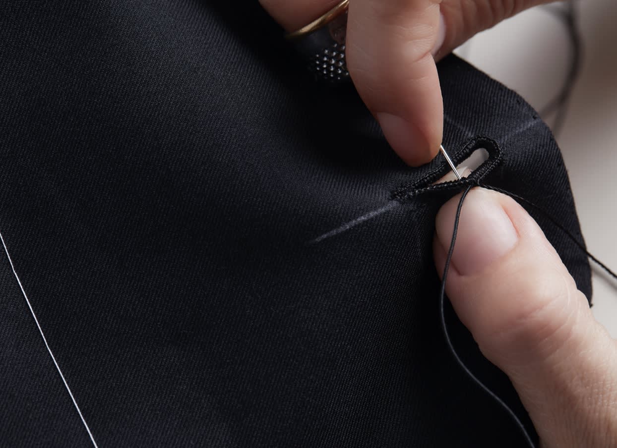 A buttonhole is hand stitched by a Brioni artisan