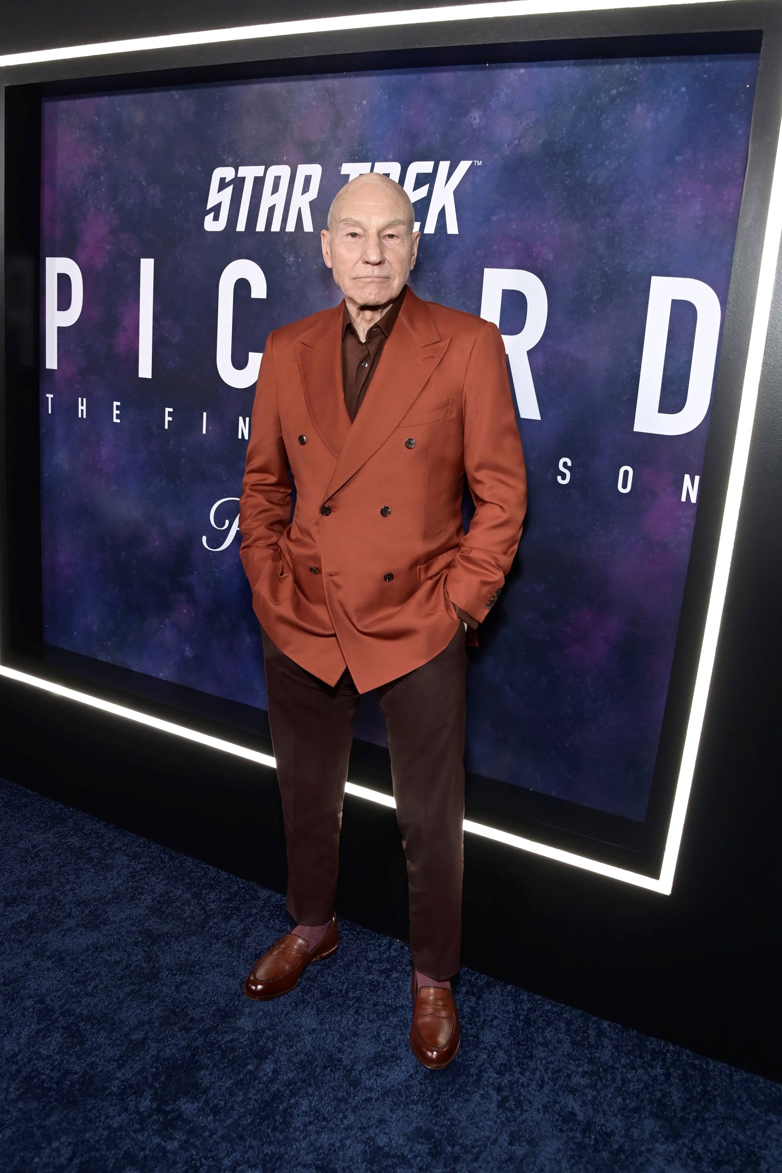 Patrick Stewart wearing a Brioni brown suit