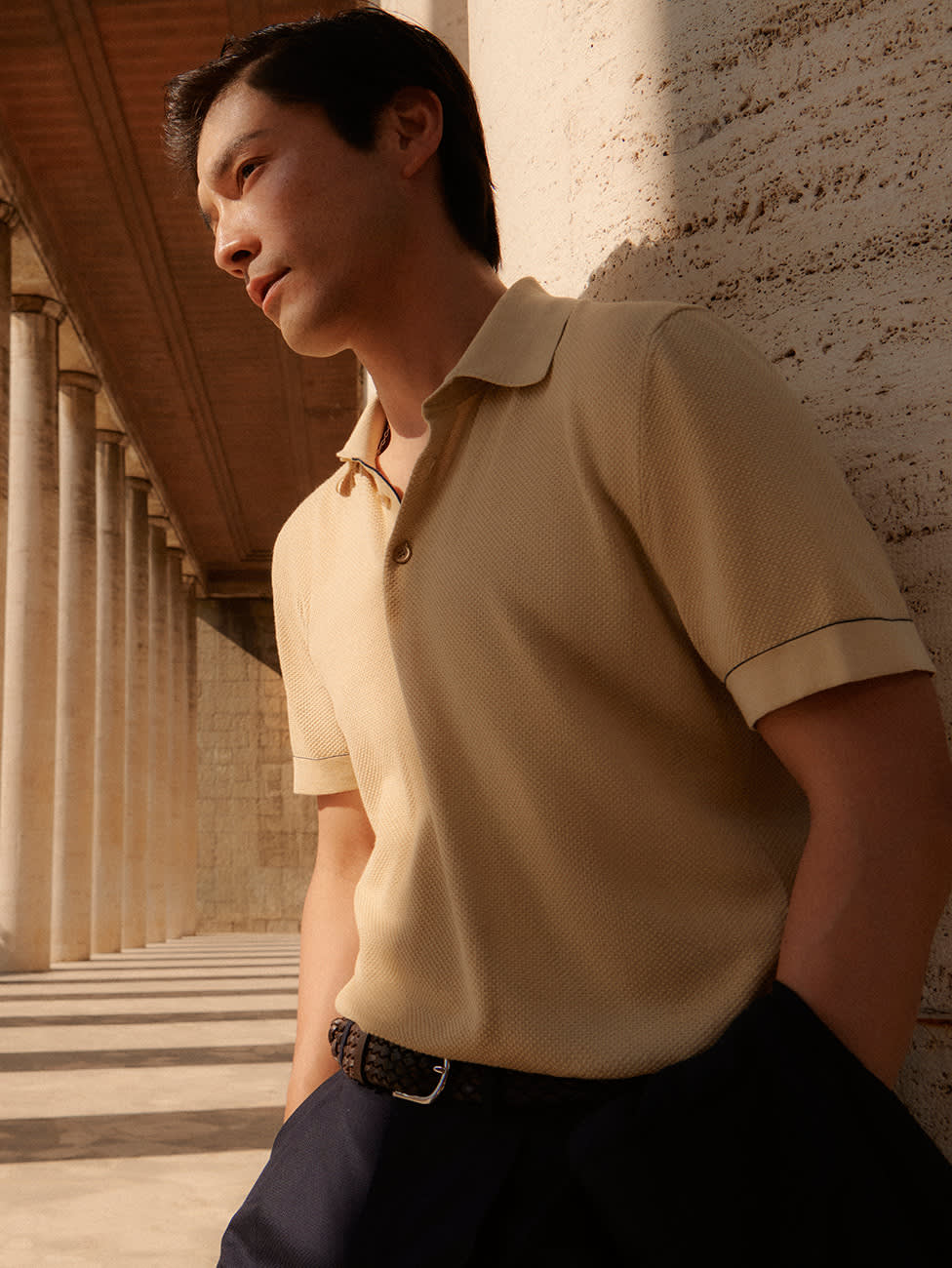 Brioni model wearing a yellow polo from SS23 collection