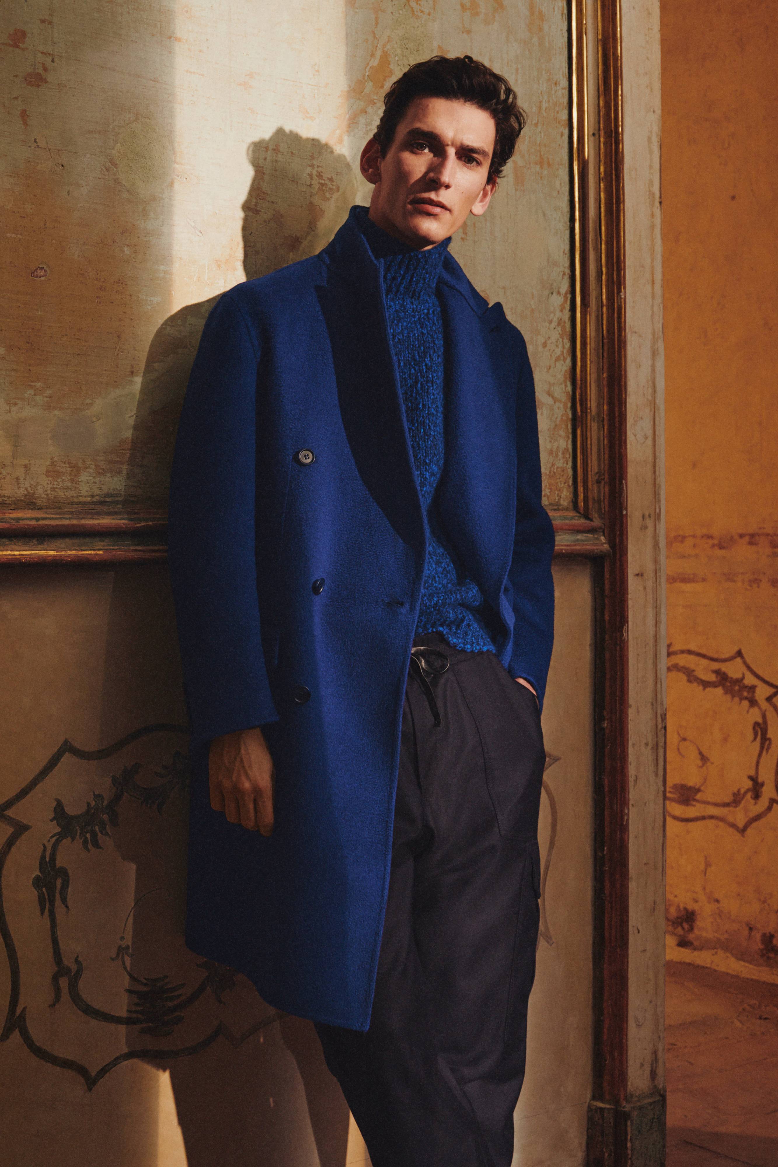 Brioni model wearing royal blue coat and sweater from fall winter 22