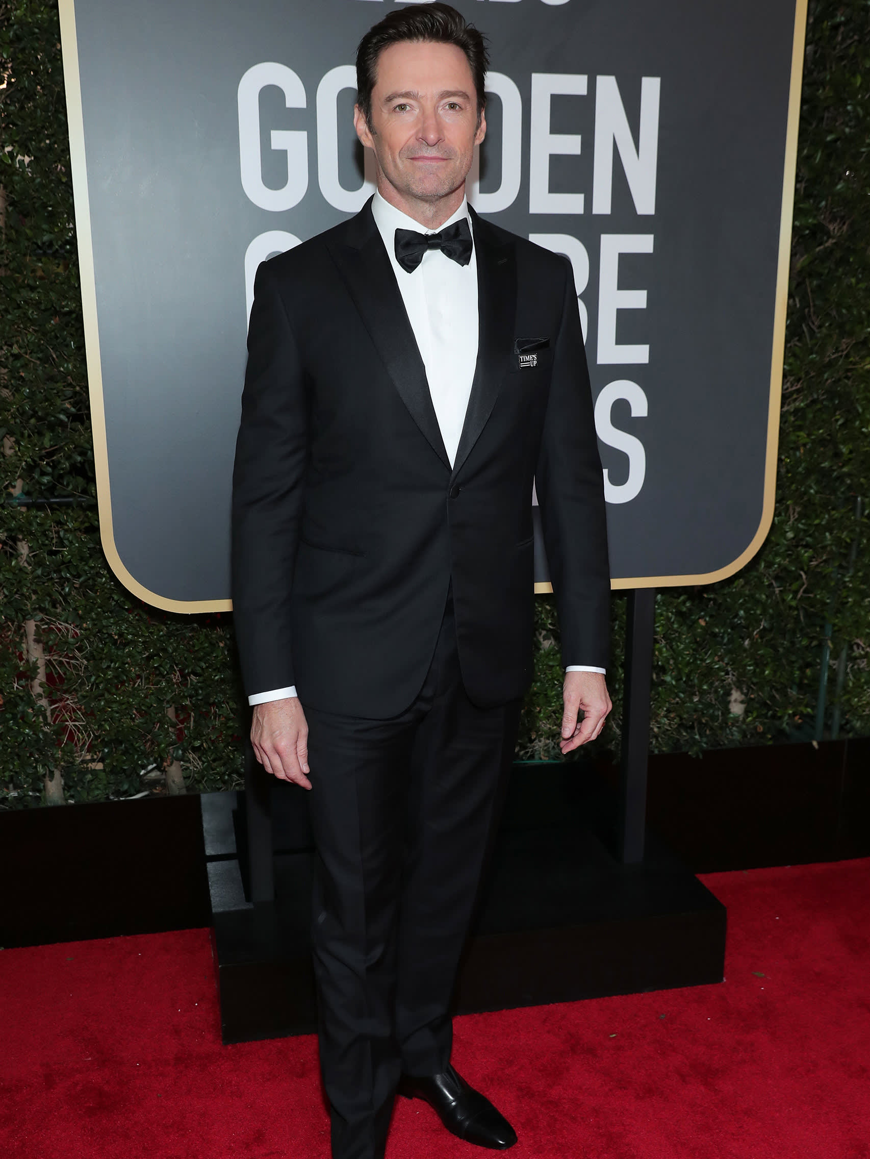 Hugh Jackman wearing a Brioni bespoke black tuxedo
