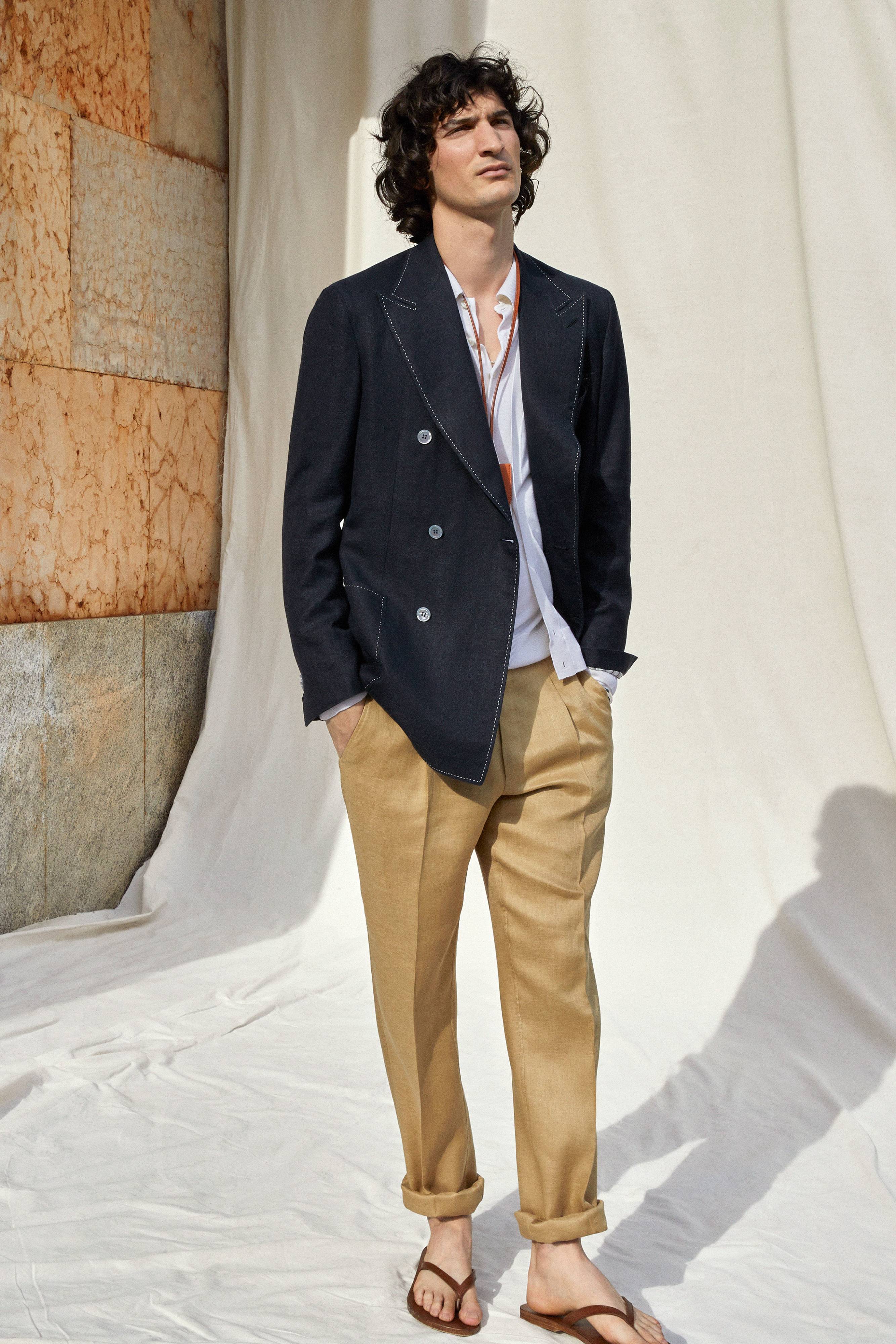 Brioni model wearing blu jacket and beige trousers from ss22 collection