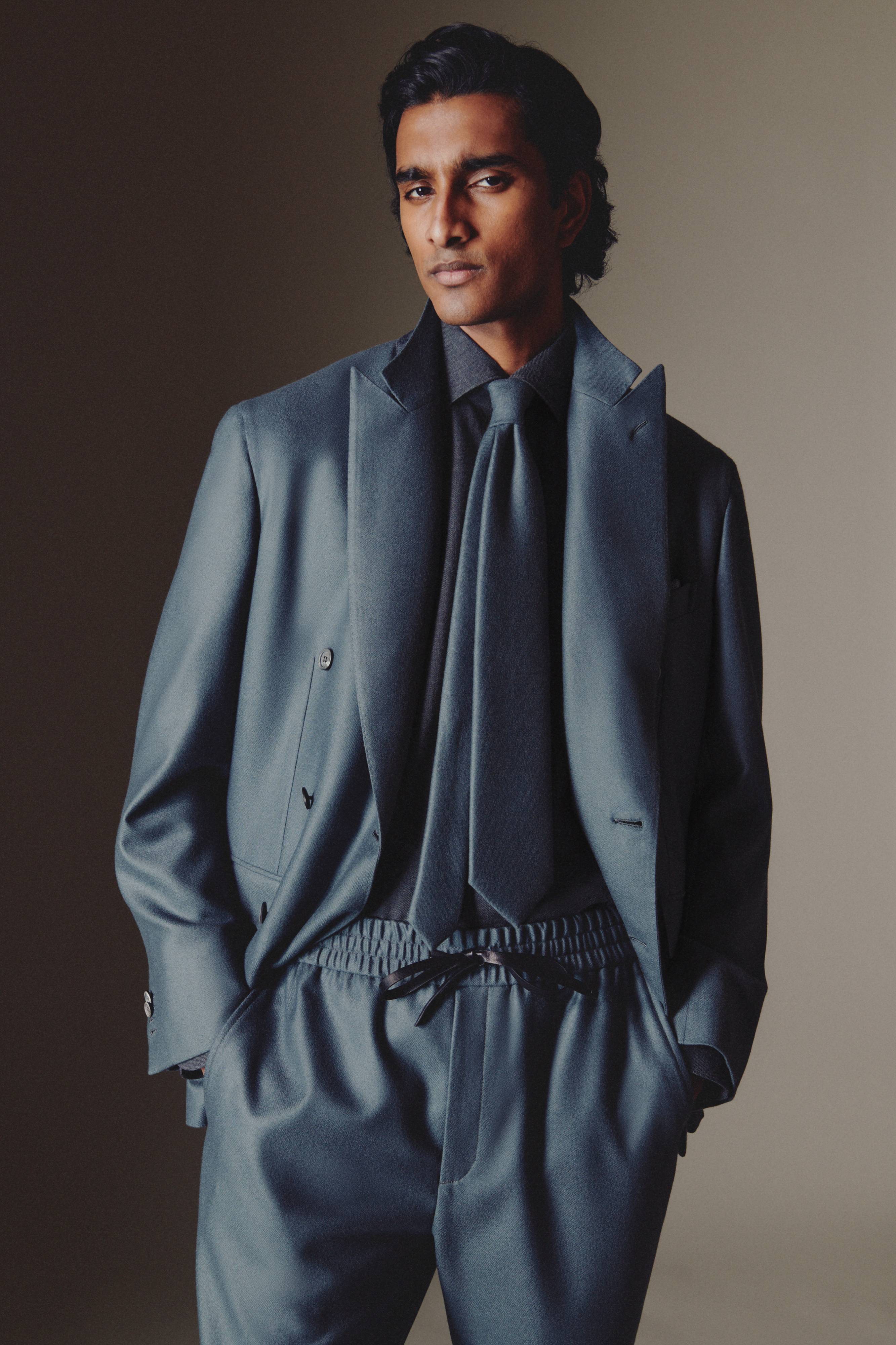 Brioni model wearing steel blue jacket and trousers from fall winter 22 collection 