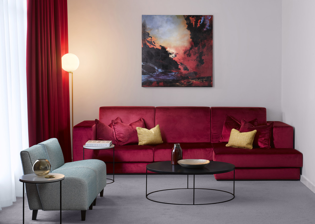 The colour scheme picks up accents of Rankle's bespoke piece of art in the interior design for each suite