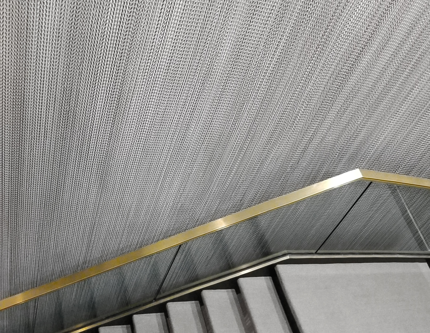 The continuous chain curtain is  a visual play on connectivity and a moving sculptural element which runs down through all 5 floors that are linked by the central stair