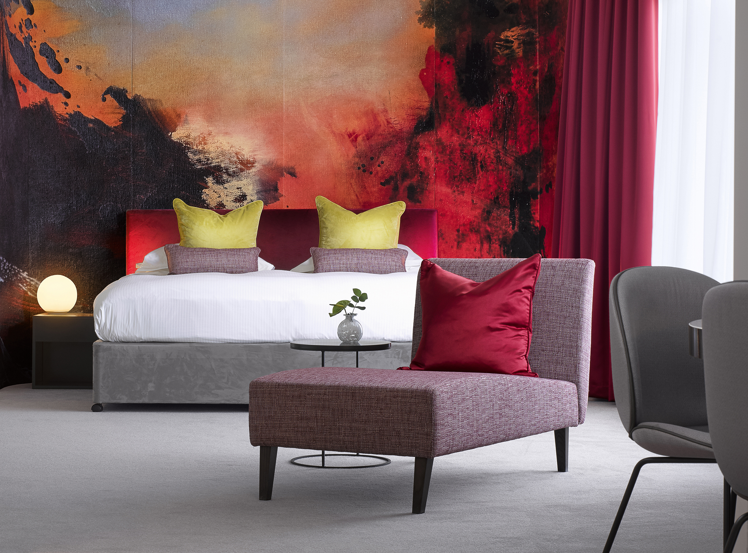 The oversized headboard features a print of painter Alan Rankle's bespoke pieces of art commissioned for the refurbished suites