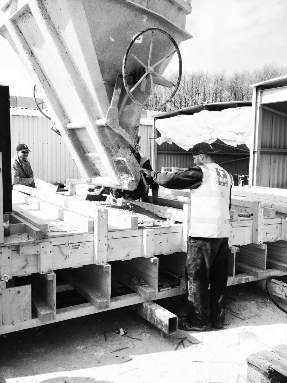 Pouring the concrete into the timber moulds