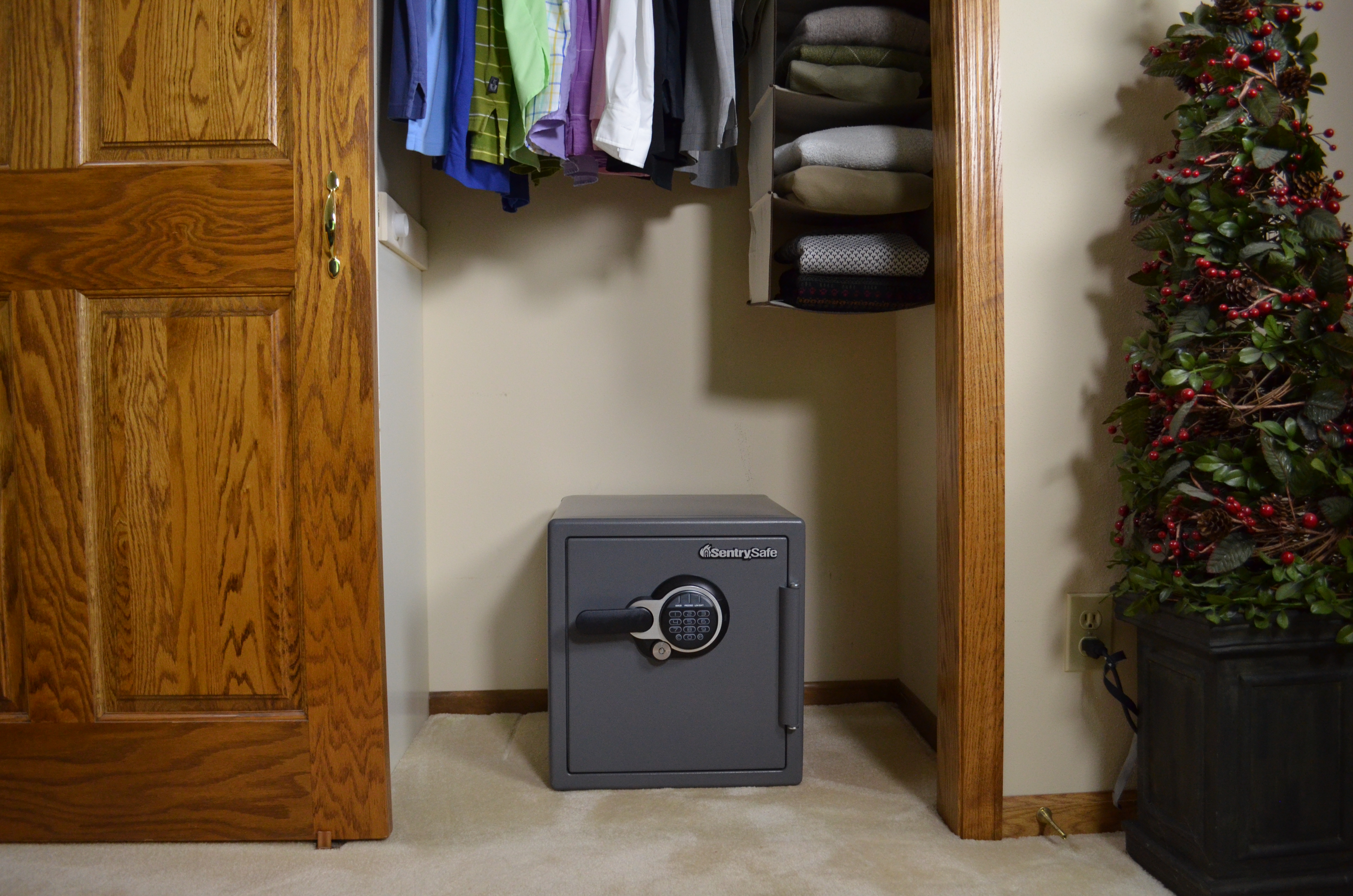 SentrySafe SFW123GDC fire and waterproof safe placed on a closet floor