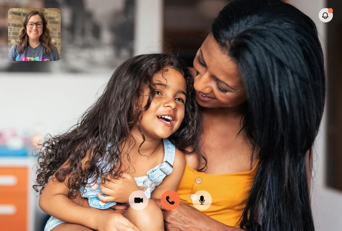 Mother holding young child during online speech therapy video session with Expressable therapist