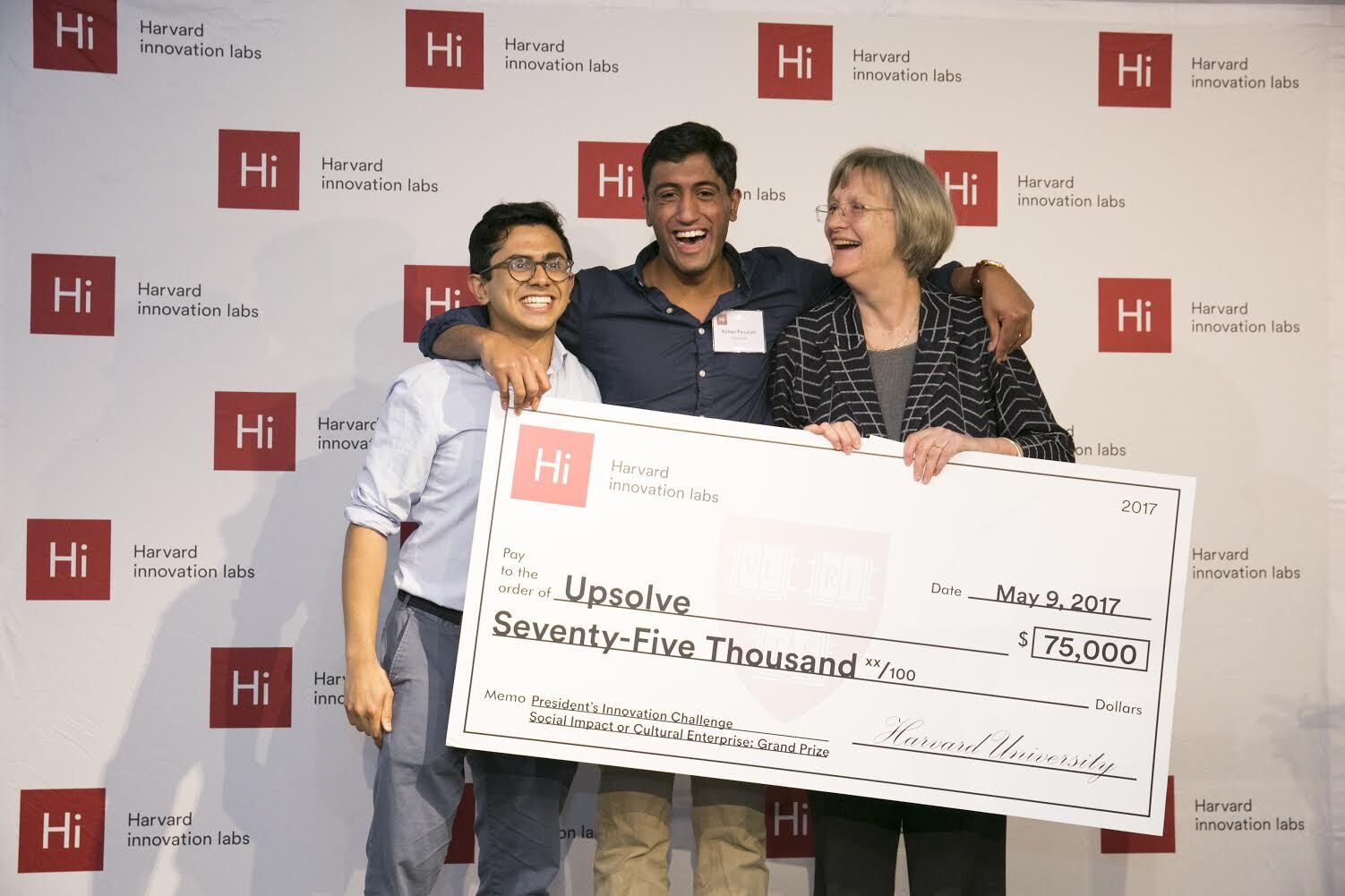 Upsolve CEO Rohan Pavuluri accepts $75,000 Grand Prize from Harvard President Drew Faust; also pictured is Milton Syed, engineer.