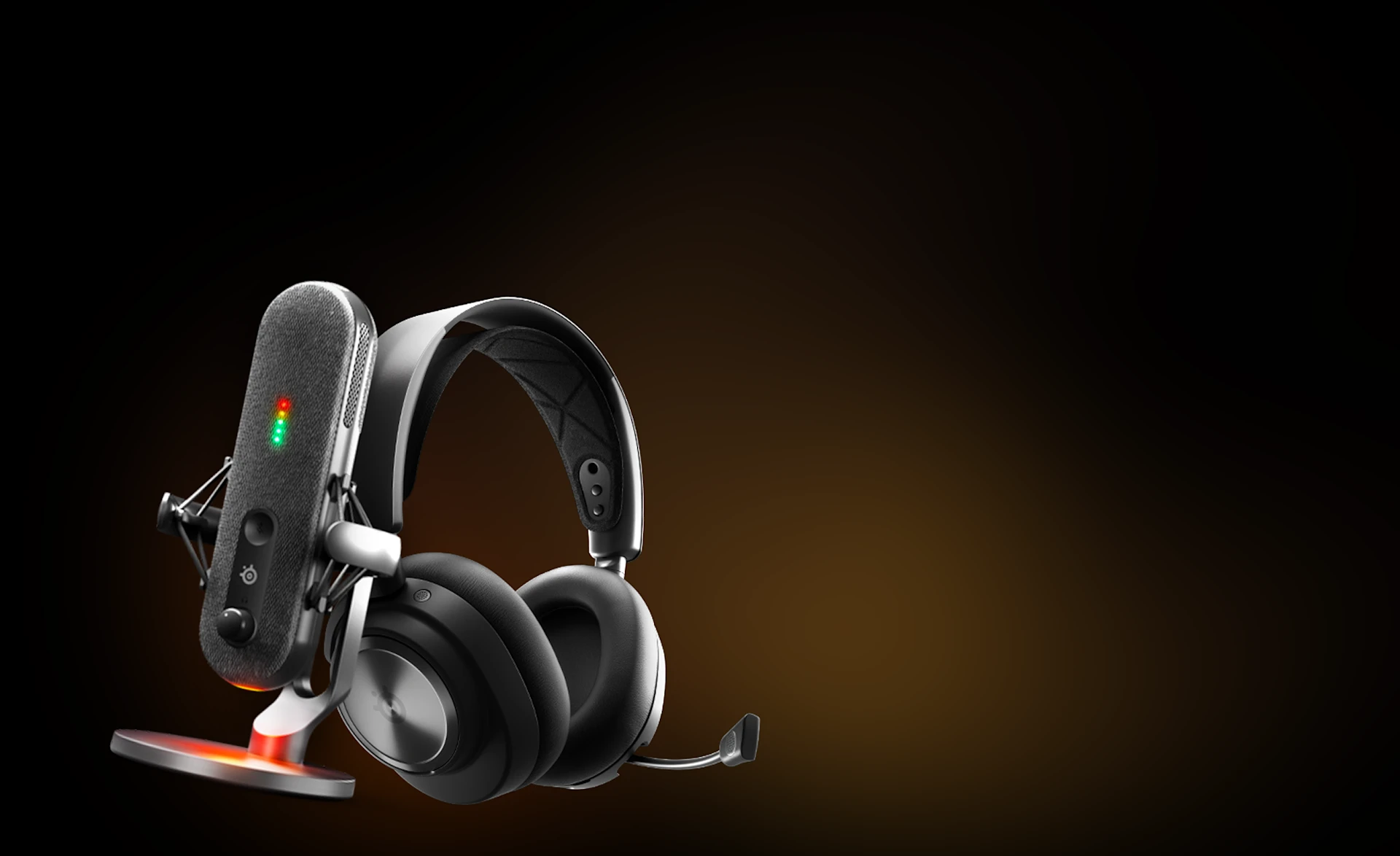 A SteelSeries streaming microphone with LED indicators and a black wireless gaming headset against a dark, warm-toned background.