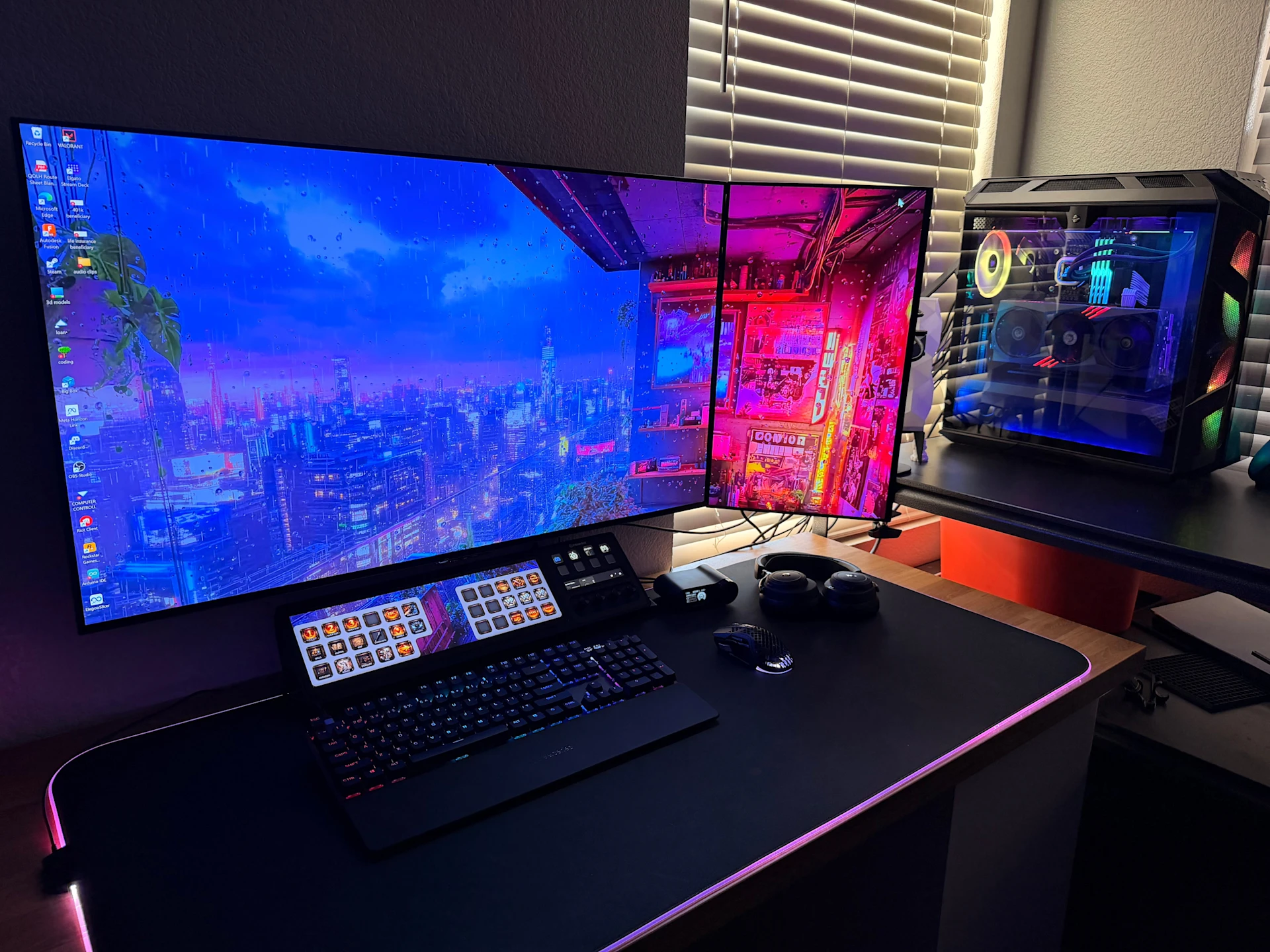 a gaming setup with dual screen and Black PC with Blue RGB and transparent windows featuring SteelSeries Gear