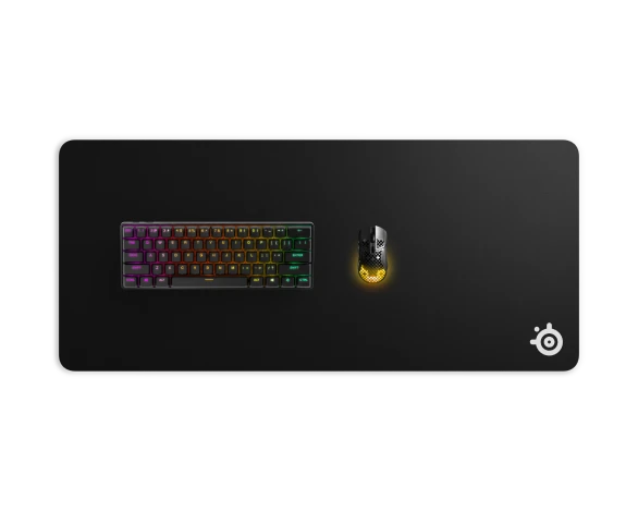 QCK mouse pad in xxl size with gaming keyboard and mouse laying on it; view from the top.