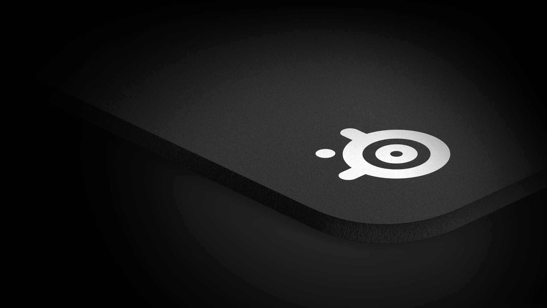 View on a corner of qck heavy mousepad with big white steelseries logo on it.
