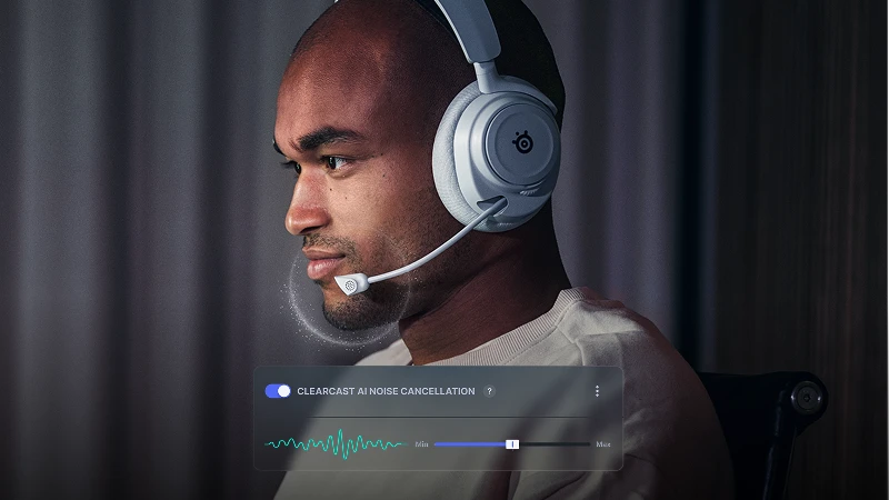 A man wearing a white gaming headset with a microphone, shown using noise cancellation.