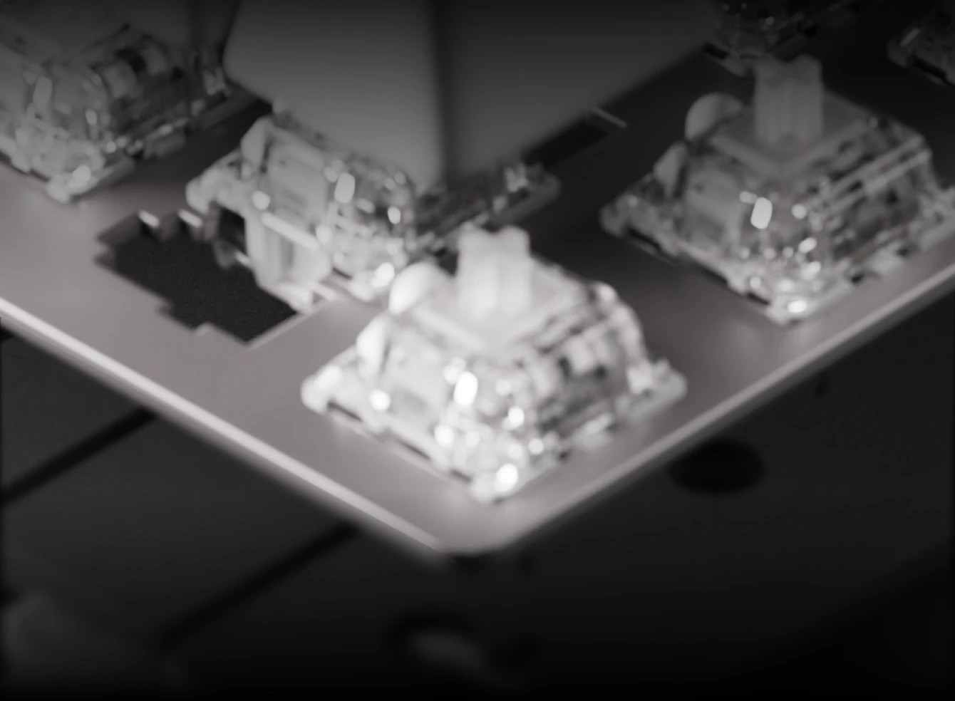 Detailed shot of the durable aluminum top plate and custom switches of the Apex Pro Gen 3.