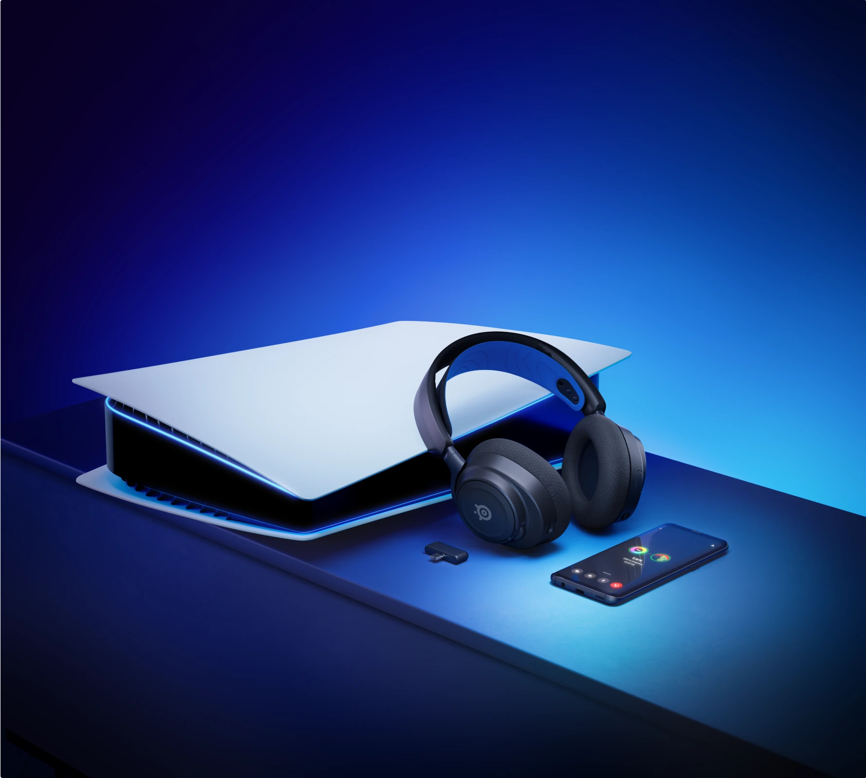 Arctis nova 5 accompanied by playstation console a dongle and phone.