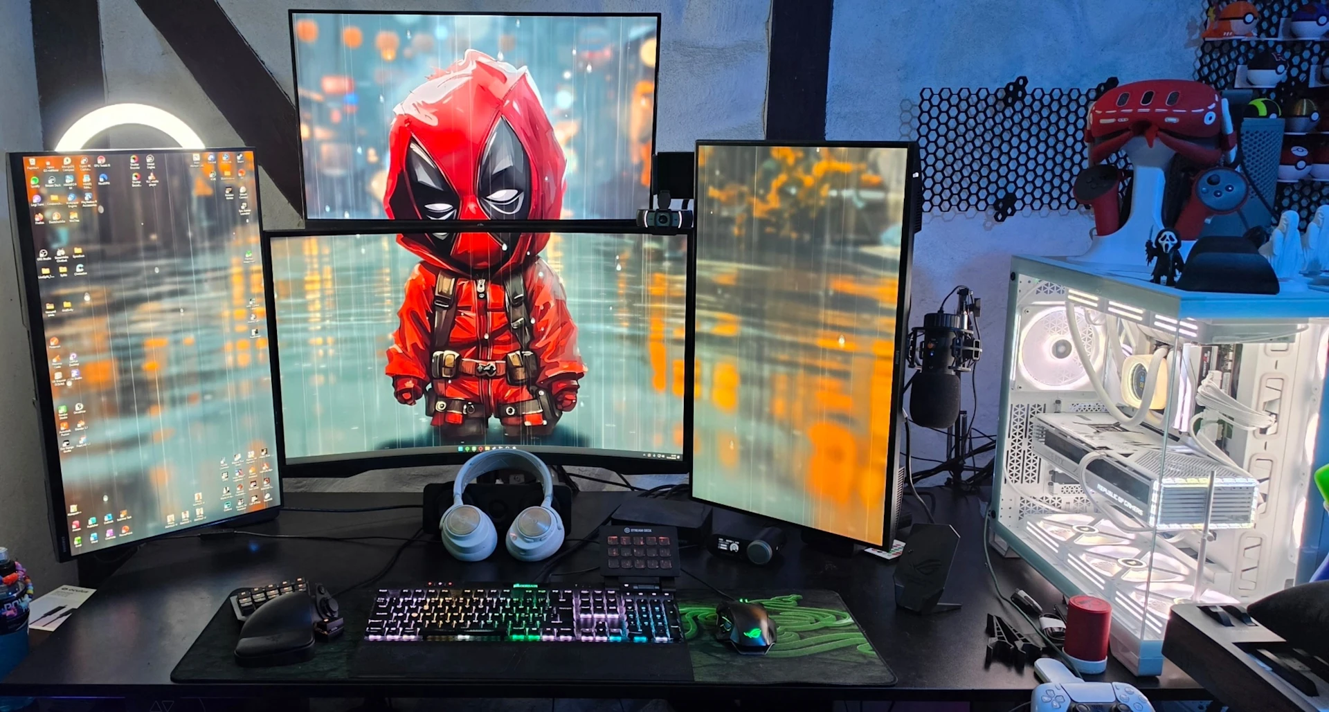 a High-tech Setup with 4 screen and with a deadpool wallpaper with white PC with transparent windows featuring SteelSeries Devices