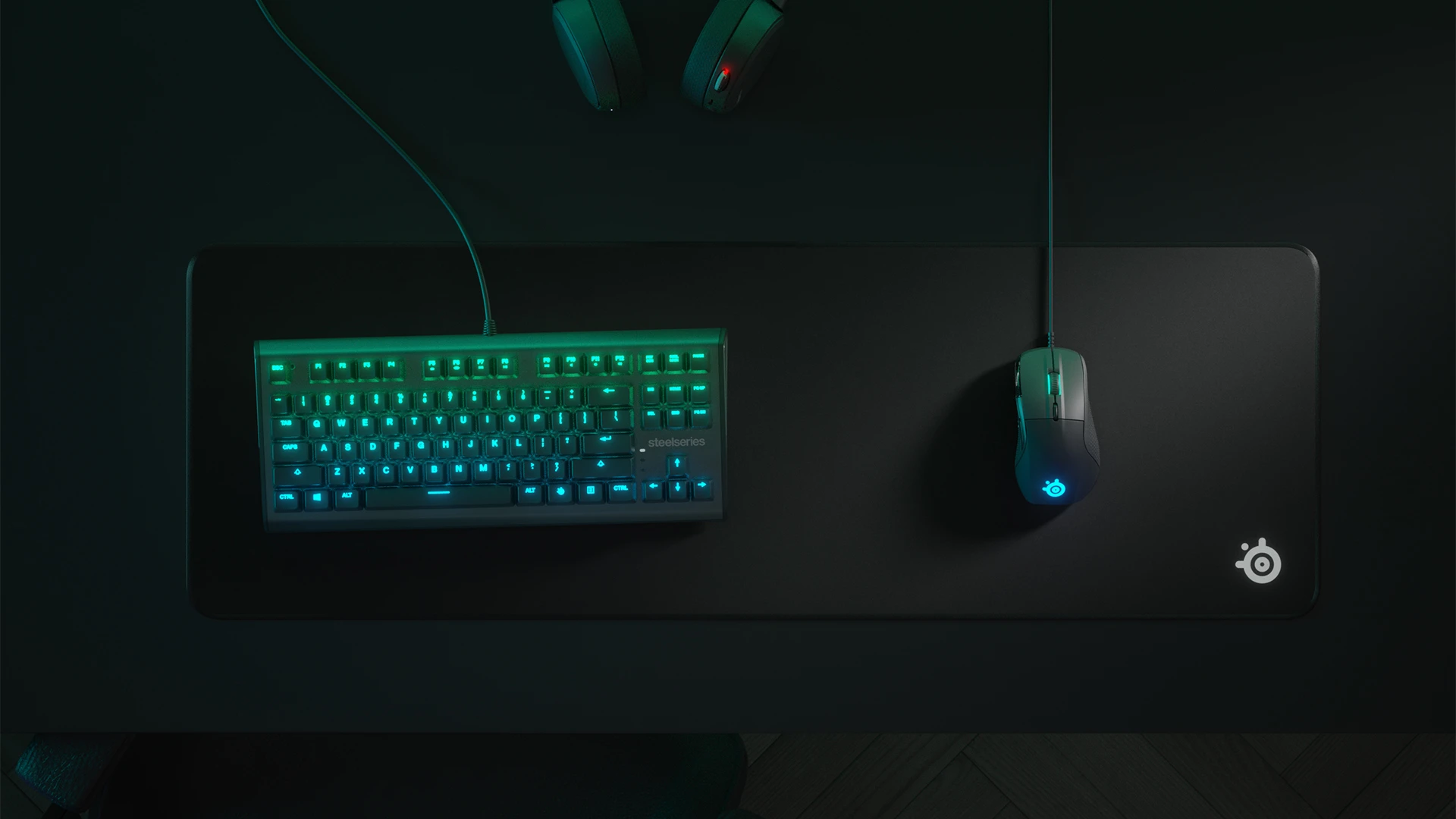 Top view of an RGB keyboard and QcK Edge mousepad with a mouse; everything in shades of green