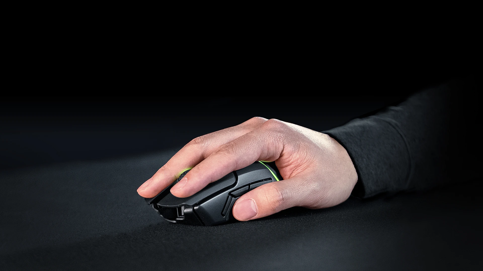 Hand resting on the mouse, which is on the QcK Heavy mousepad.