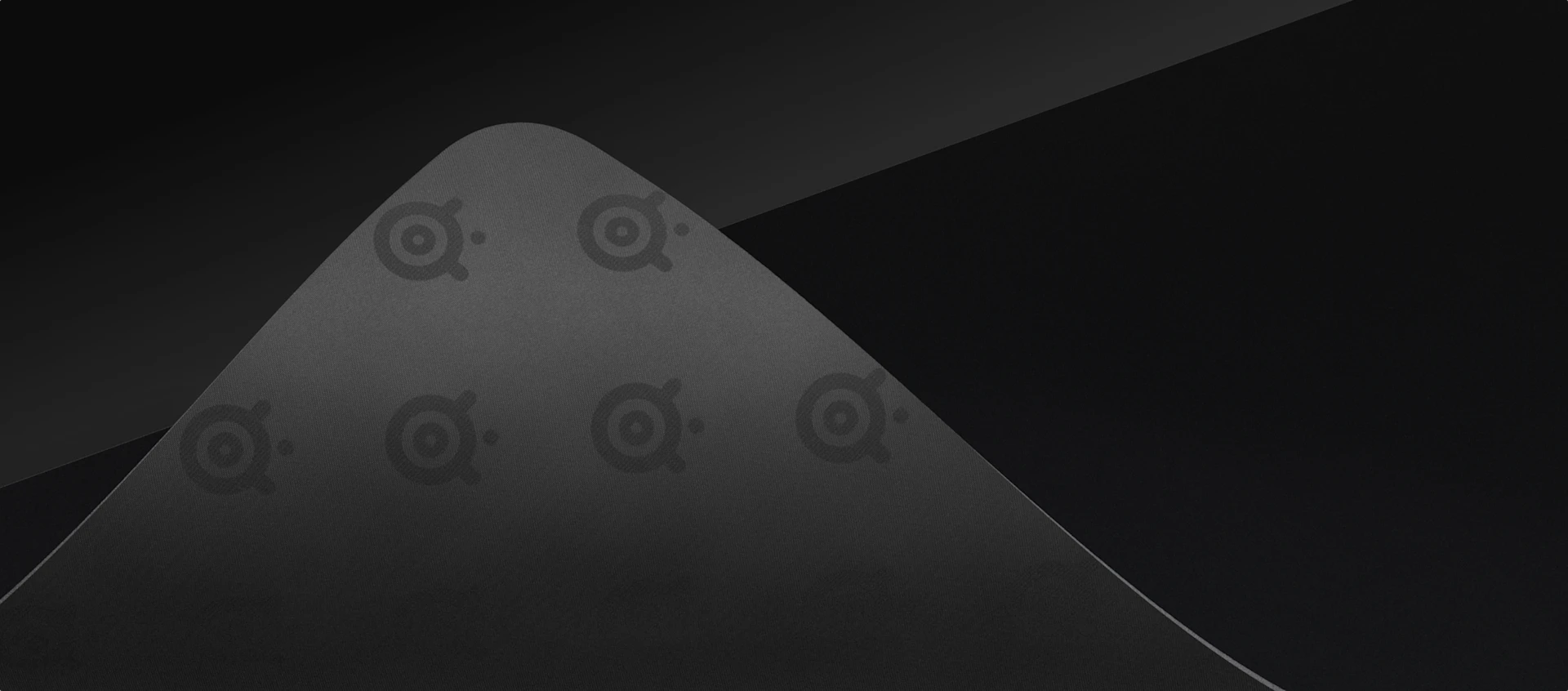 Corner of the QcK mouse pads is folded;back surface showing steelseries logos.