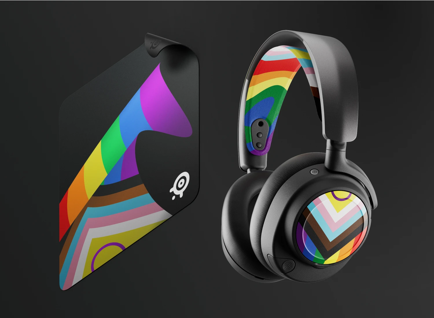 SteelSeries limited edition Pride 2026 gaming accessories bundle featuring the Arctis Nova booster pack with rainbow headband and speaker plates, and a matching QcK Large mousepad on a dark background.