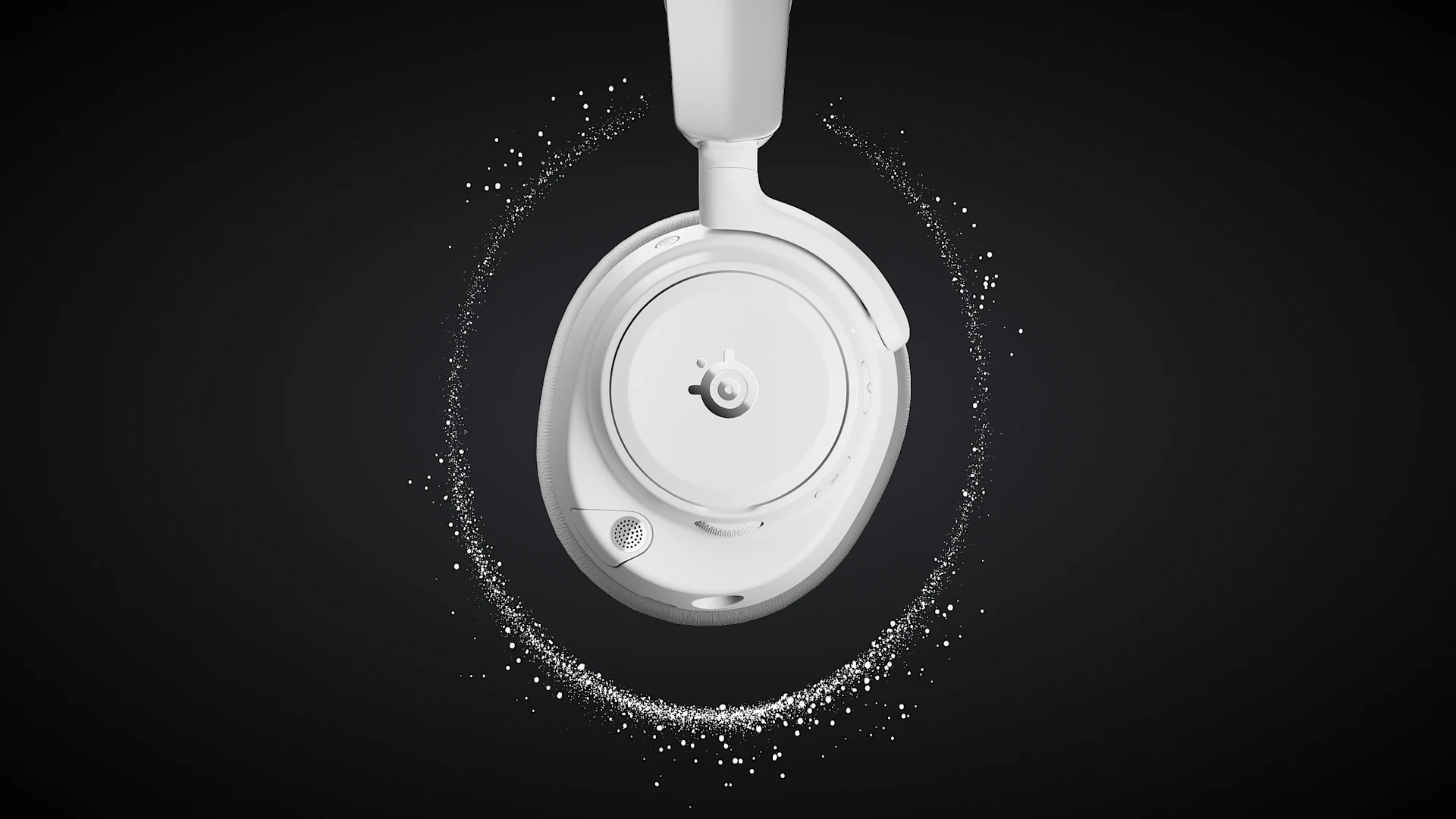 Close-up of one earcup of over-ear gaming headset, surrounded by a glowing ring of white sound particles on a dark background.