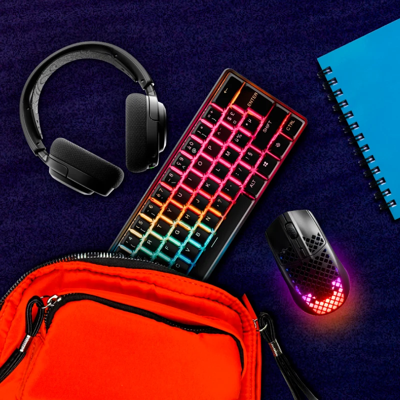 An image of assorted SteelSeries gear pictured with a backpack and notebook.