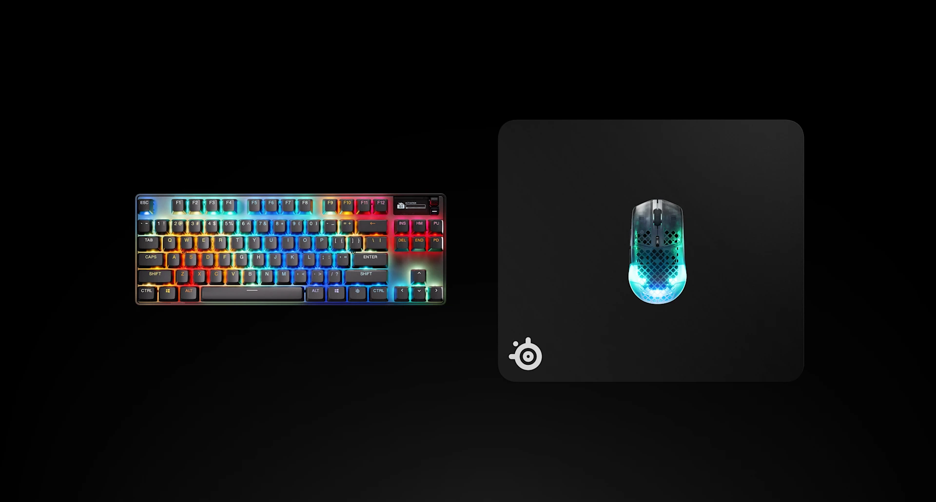 Widok z góry na czarną podkładkę pod mysz SteelSeries QcK Heavy L z mechaniczną klawiaturą RGB i myszą do gier Aerox.