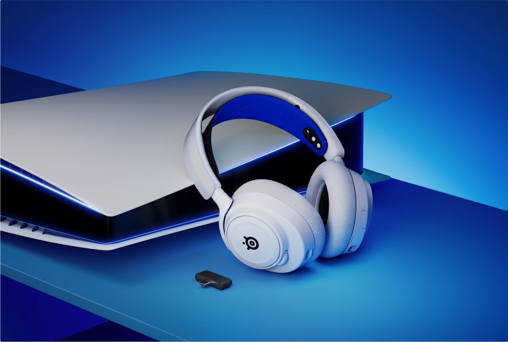 A white and blue SteelSeries Arctis 7P+ wireless gaming headset shown next to a PlayStation 5 console.