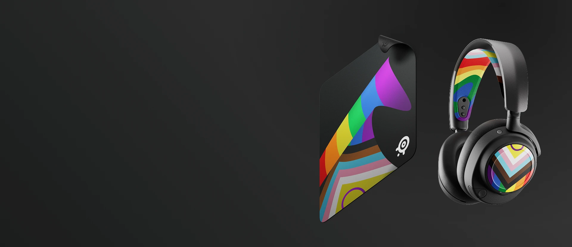SteelSeries limited edition Pride 2026 gaming accessories bundle featuring the Arctis Nova booster pack with rainbow headband and speaker plates, and a matching QcK Large mousepad on a dark background.