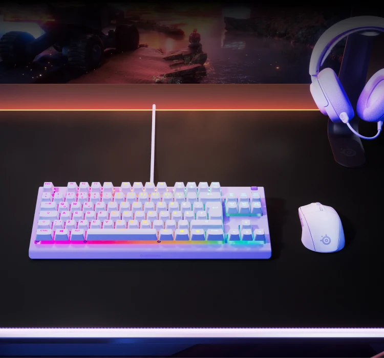 Apex 3 TKL keyboard on a desk together with gaming mouse