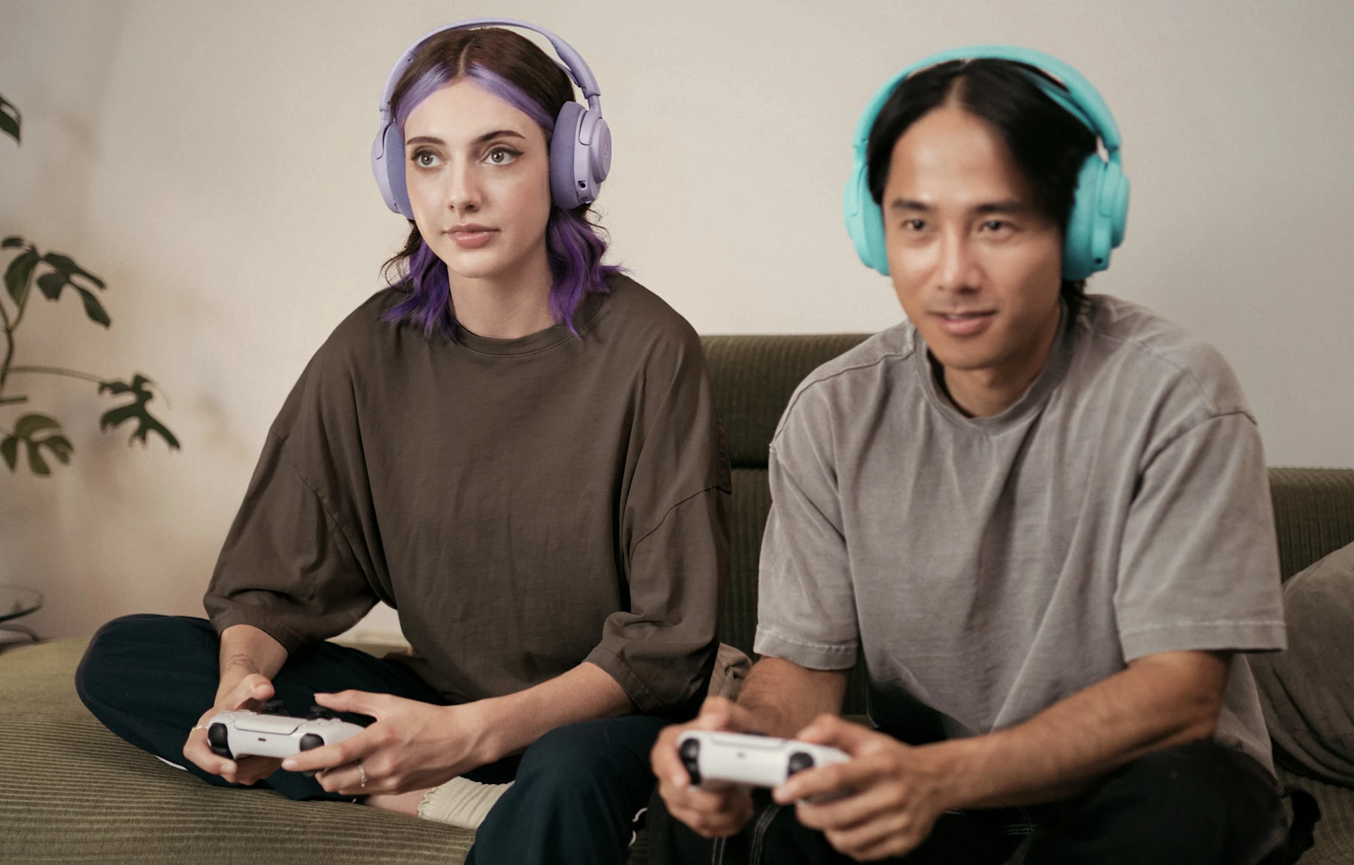2 people with headphones on play on console