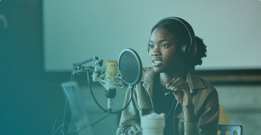 Women speaking through a studio microphone and wearing an headset.