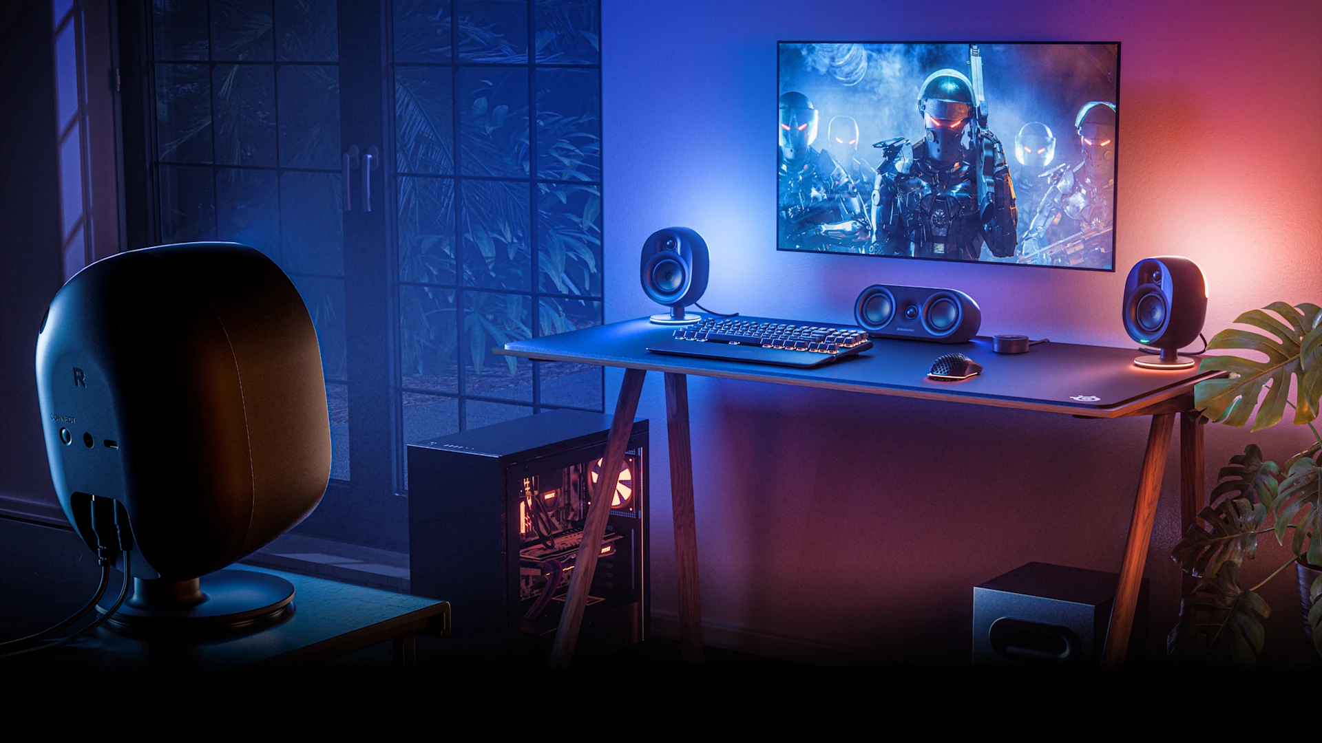 gaming setup in a room illuminated by colorful lights