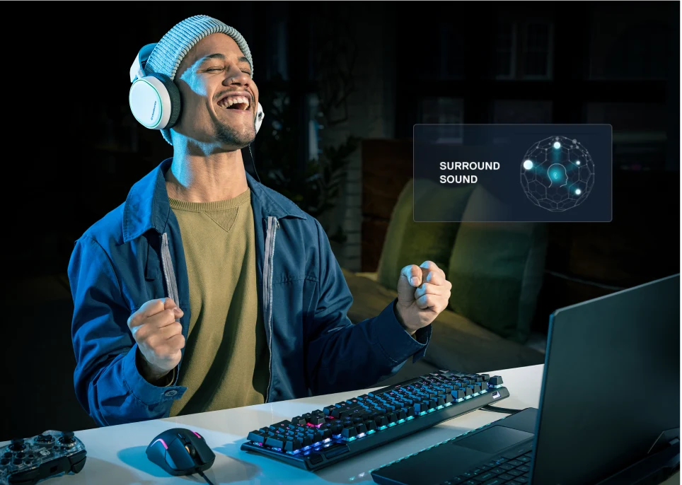 Winning gamer in front of his gaming laptop PC. Nahimic Surround Sound logo is displayed.