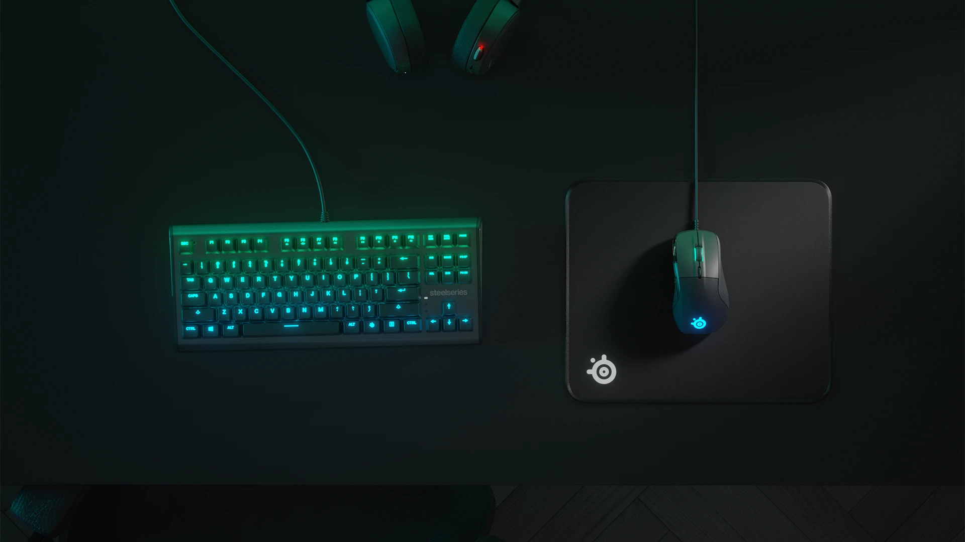 Top view of an RGB keyboard and QcK Edge mousepad with a mouse; everything in shades of green